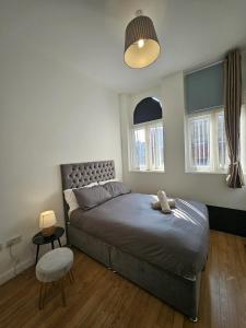 a bedroom with a bed with a teddy bear on it at City Centre stay in Liverpool