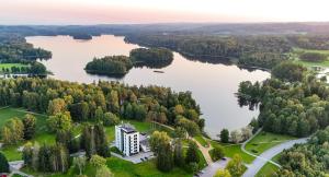 an aerial view of a lake with a building at GMP Clubhotel Apartments in Otepää