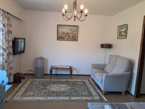 a living room with a couch and a chair at Koivulehto in Heinävesi