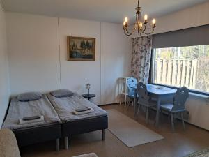 a bedroom with a bed and a table and chairs at Koivulehto in Heinävesi