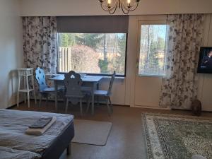 a living room with a dining room table and chairs at Koivulehto in Heinävesi