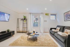 a living room with a couch and a table at Spacious apartment-2BR-4P in Le Kremlin-Bicêtre +5 photos