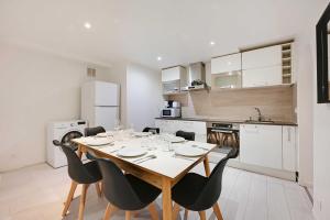 a kitchen and dining room with a table and chairs at Spacious apartment-2BR-4P in Le Kremlin-Bicêtre