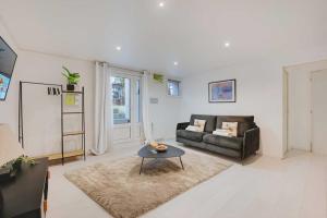 a living room with a couch and a table at Spacious apartment-2BR-4P in Le Kremlin-Bicêtre