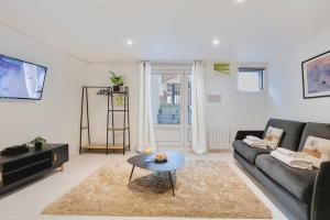 a living room with a couch and a table at Spacious apartment-2BR-4P in Le Kremlin-Bicêtre