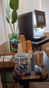 a table with a microwave and a tray of dishes at H22 Hotel in Naples