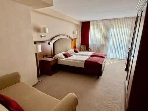 a hotel room with a bed and a chair at Burghotel Nürnberg in Nuremberg +75 photos