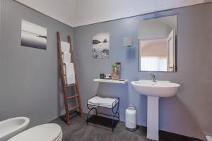 a bathroom with a sink and a toilet and a mirror at Pantelleria Dream Resort in Pantelleria