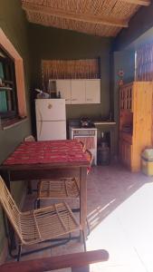 a kitchen with a table and chairs and a stove at El MasSi in Tilcara
