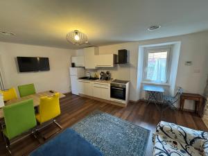 a kitchen and living room with a table and chairs at Apartment LA DIMORA DEI PESCATORI in Muggia