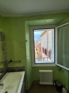 a bathroom with a window and a bath tub at Apartment LA DIMORA DEI PESCATORI in Muggia +21 photos