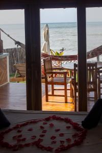 a woman standing on a porch looking out at the ocean at Primaluna Romantica in La Punta de los Remedios