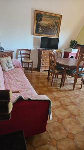 a living room with a table and chairs and a dining room at Adri's House in Monterotondo
