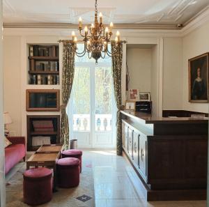 a living room with a chandelier and a large window at Hotel Dom Sancho I in Lisbon +19 photos
