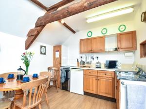 a kitchen with a wooden table and a dining room at 3 Bed in Stocksfield oc-32252 in Stocksfield