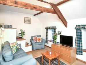 a living room with a couch and a tv at 3 Bed in Stocksfield oc-32252 in Stocksfield