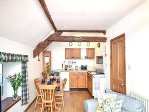 a kitchen and living room with a table and chairs at 3 Bed in Stocksfield oc-32252 in Stocksfield +11 photos