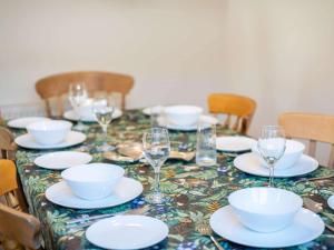 a table with plates and wine glasses on it at 3 Bed in Swanage oc-84019 in Swanage +11 photos