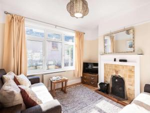 a living room with a couch and a fireplace at 3 Bed in Swanage oc-84019 in Swanage