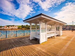 a gazebo on a pier next to the water at 3 Bed in Swanage oc-84019 in Swanage