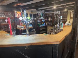 a bar with a wooden counter in a pub at The Kings Arms in Cleobury Mortimer