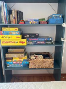 a book shelf filled with books and a basket of books at Residence at lake Balaton in Siófok