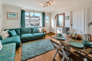 a living room with a green couch and a table at 2 Bed in Mullion oc-k7968 in Mullion