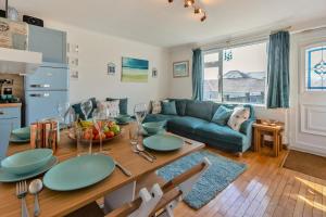 a living room with a table and a couch at 2 Bed in Mullion oc-k7968 in Mullion +17 photos