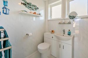 a white bathroom with a toilet and a sink at 2 Bed in Mullion oc-k7968 in Mullion