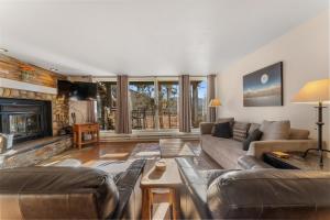 a living room with a couch and a fireplace at Pines #2165 in Keystone