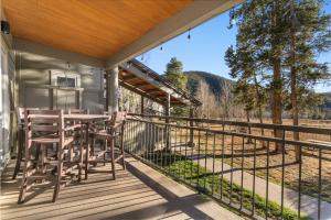 a patio with a table and chairs on a deck at Pines #2165 in Keystone