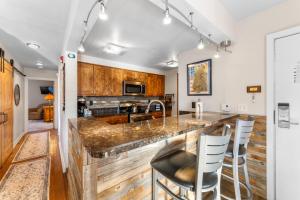 a kitchen with a large counter with bar stools at Pines #2165 in Keystone