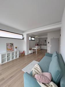 a living room with a blue couch and a table at Warm Apartment 1 in Bucharest