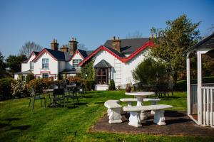 a group of tables and chairs in a yard at Killeen House Hotel in Killarney