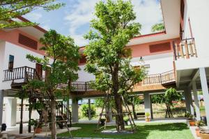 a building with trees in front of it at Ban Klong Srabua in Phra Nakhon Si Ayutthaya