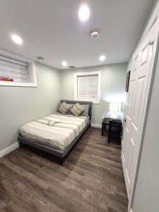 a bedroom with a bed in the middle of it at Compact,1BR Guesthouse Studio in Guelph