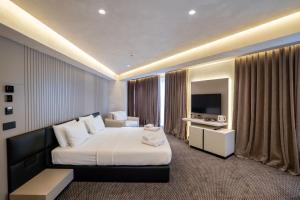a hotel room with a bed and a television at Mattis Hotel in Tirana