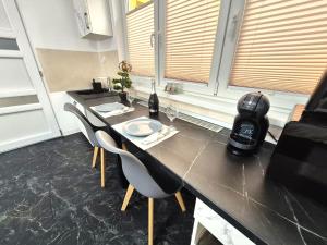 a kitchen with a table with two chairs at Central Suites Targu Mures in Târgu-Mureş