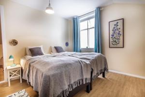 a bedroom with a bed and a window at Englendingavík Homestay in Borgarnes