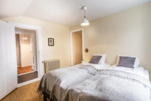 a white bedroom with a large bed in it at Englendingavík Homestay in Borgarnes +173 photos