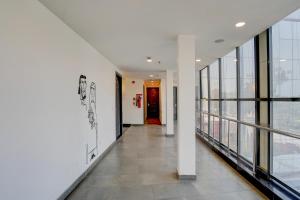 a hallway in a building with large windows at OYO Townhouse Deva Road Lucknow in Lucknow