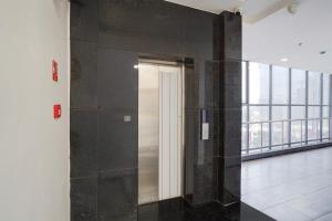 a hallway with a glass door in a building at OYO Townhouse Deva Road Lucknow in Lucknow +33 photos