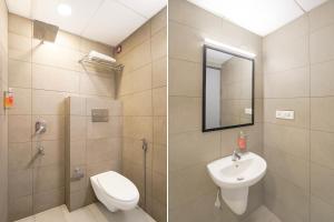 a bathroom with a sink and a toilet and a mirror at OYO Townhouse Deva Road Lucknow in Lucknow