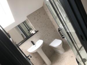 a bathroom with a toilet and a sink at Gwel Owrek in Tintagel