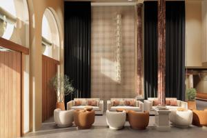a lobby with couches and chairs in a building at Serras Sevilla in Seville