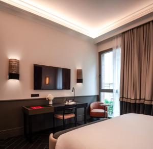 a hotel room with a bed and a desk at Serras Sevilla in Seville