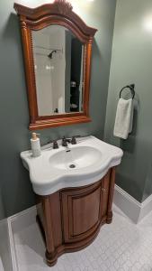 a bathroom with a sink and a mirror at Rose & Thistle B&B Lunenburg in Lunenburg +17 photos