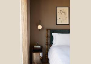 a bedroom with a bed with a picture on the wall at The Newman in London +91 photos