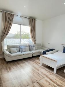 a living room with a couch and a bed at Wadi Bani Khalid - Al Joud Green Hostel in Zilaft +35 photos