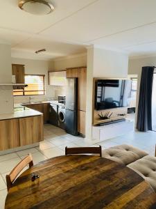 a large kitchen with a wooden table in a room at The blyde 1 bedroom in Pretoria